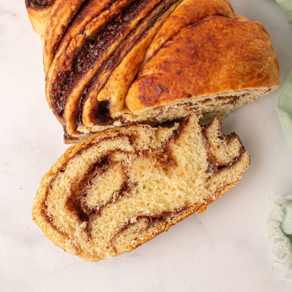 Image of a warm chocolate swirled roll of babka bread